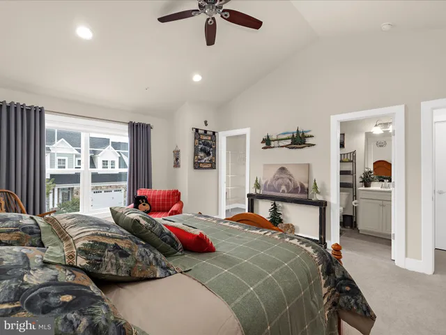 a living room with furniture a flat screen tv and a couch