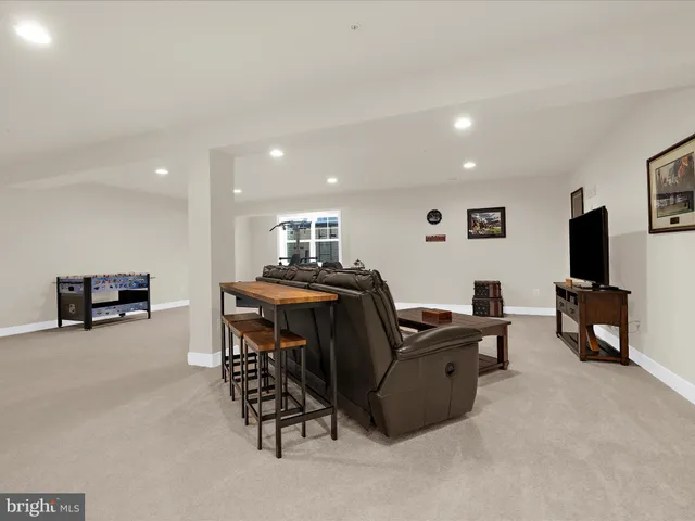 an aerial view of a house with a garden and lake view