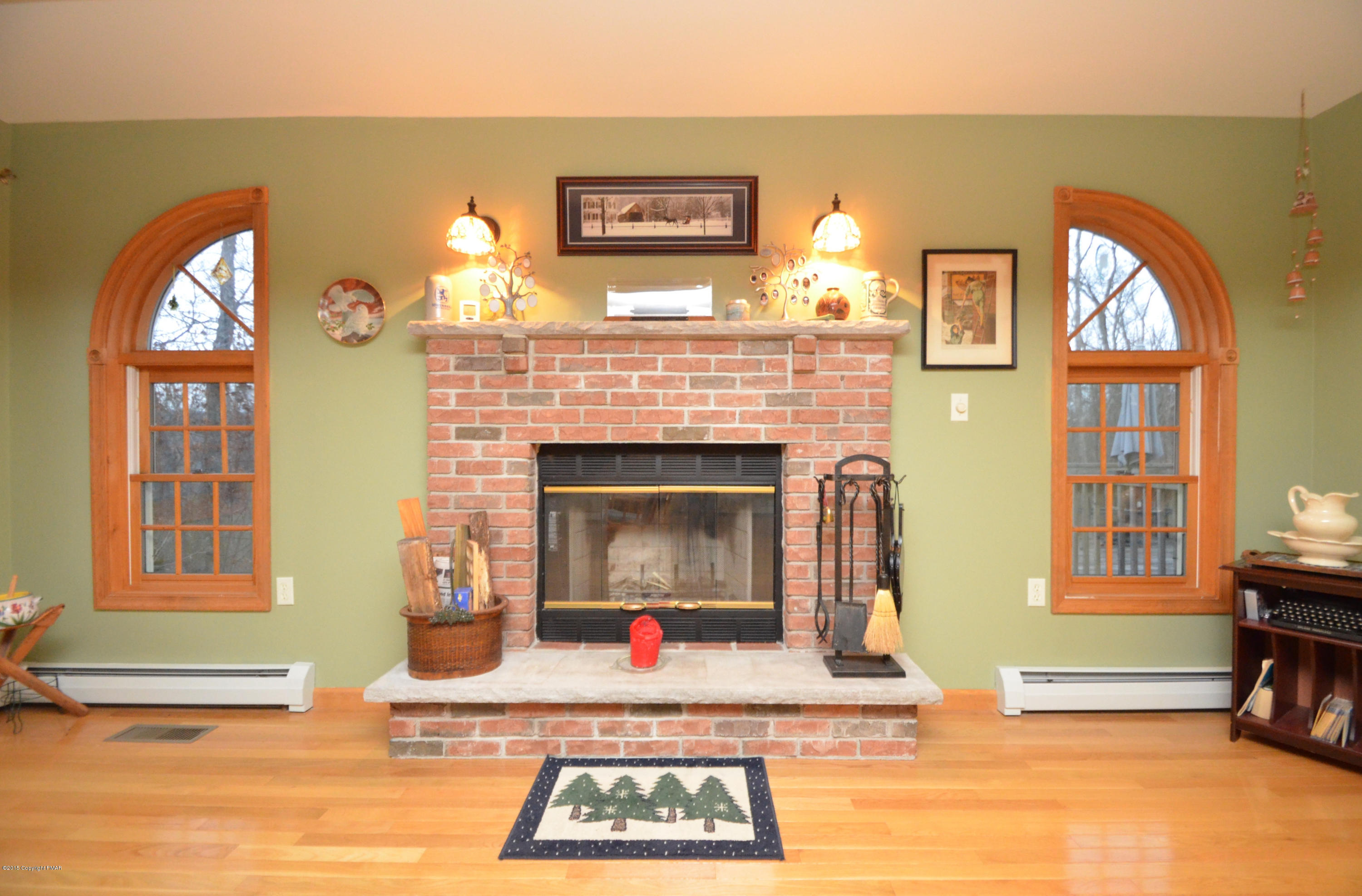 699 Buckle Boot Road Henryville, PA 18332 - Photo 12 of 26 a living room with furniture a fireplace and a flat screen tv