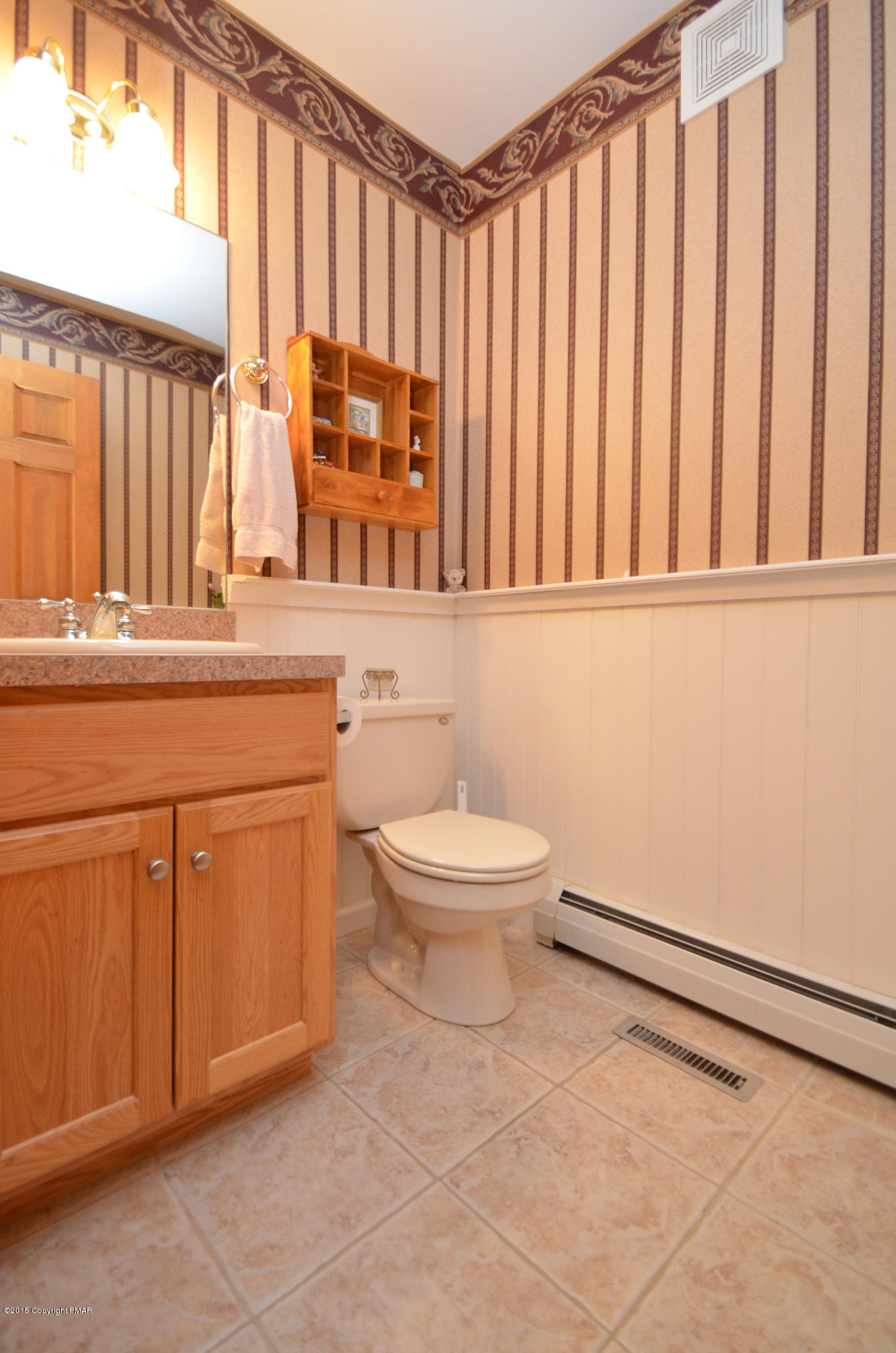 699 Buckle Boot Road Henryville, PA 18332 - Photo 13 of 26 a bathroom with a toilet a sink and a window