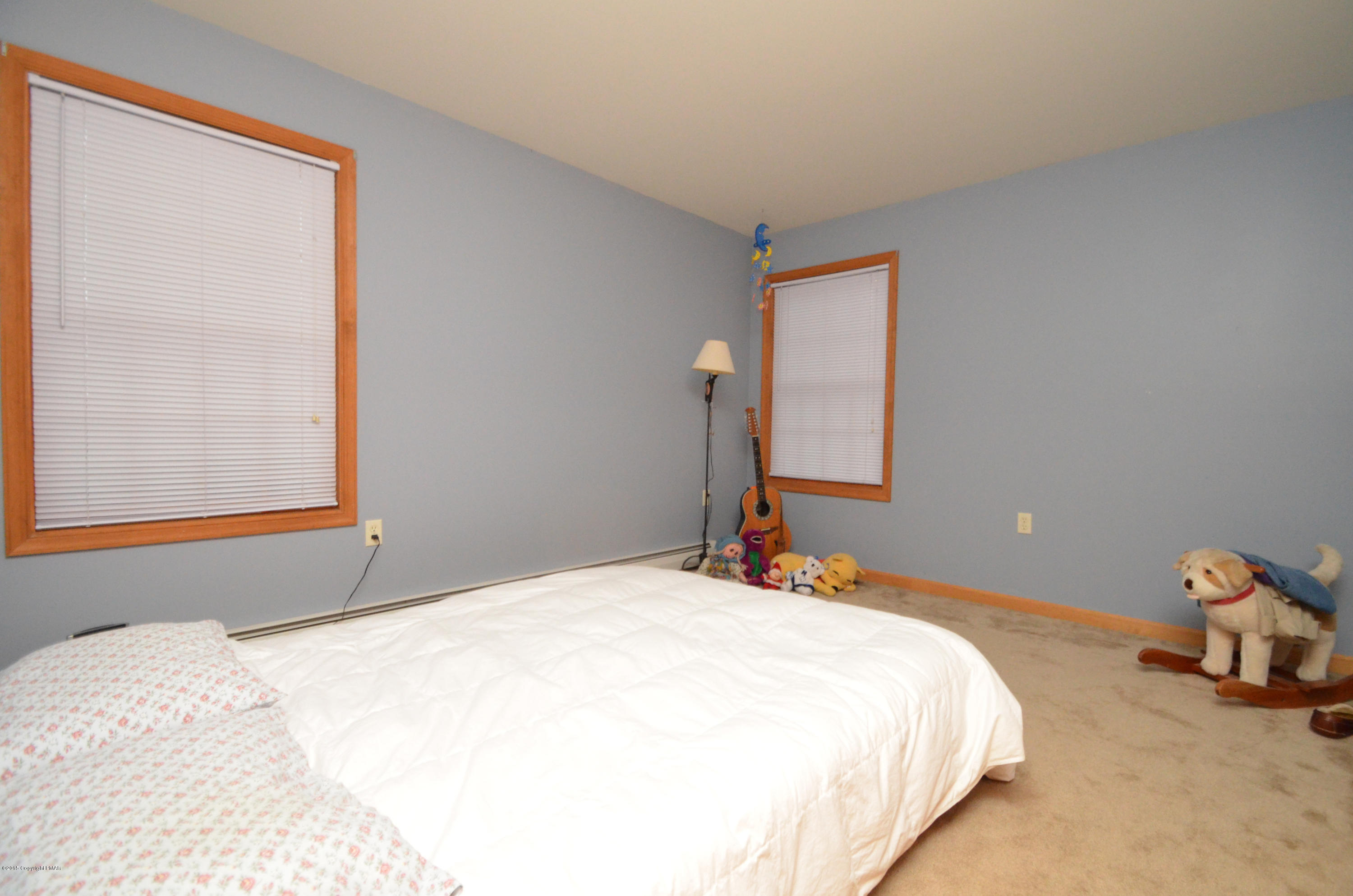699 Buckle Boot Road Henryville, PA 18332 - Photo 17 of 26 a bedroom with a bed and a window
