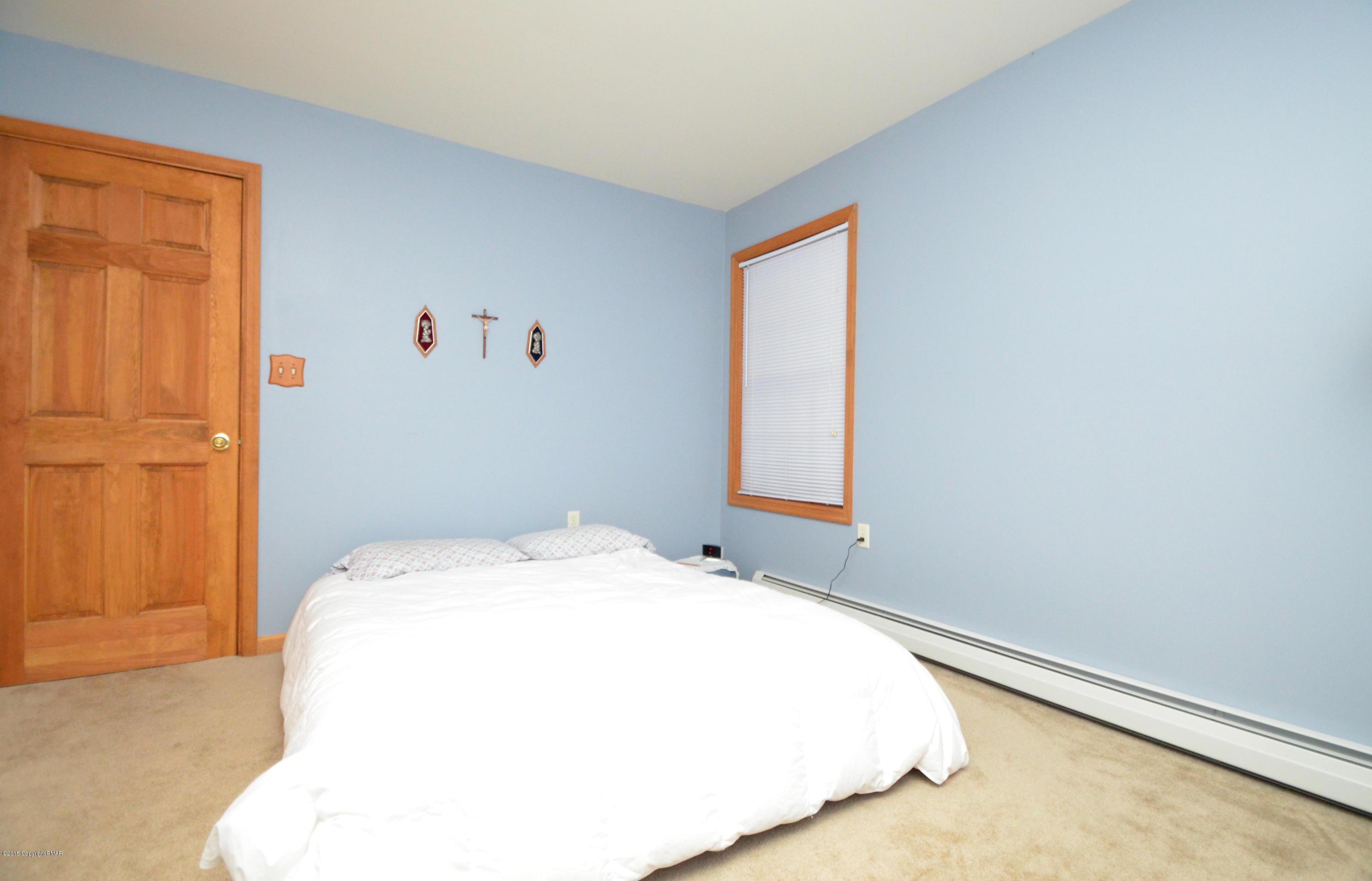 699 Buckle Boot Road Henryville, PA 18332 - Photo 18 of 26 a bedroom with a bed and a window