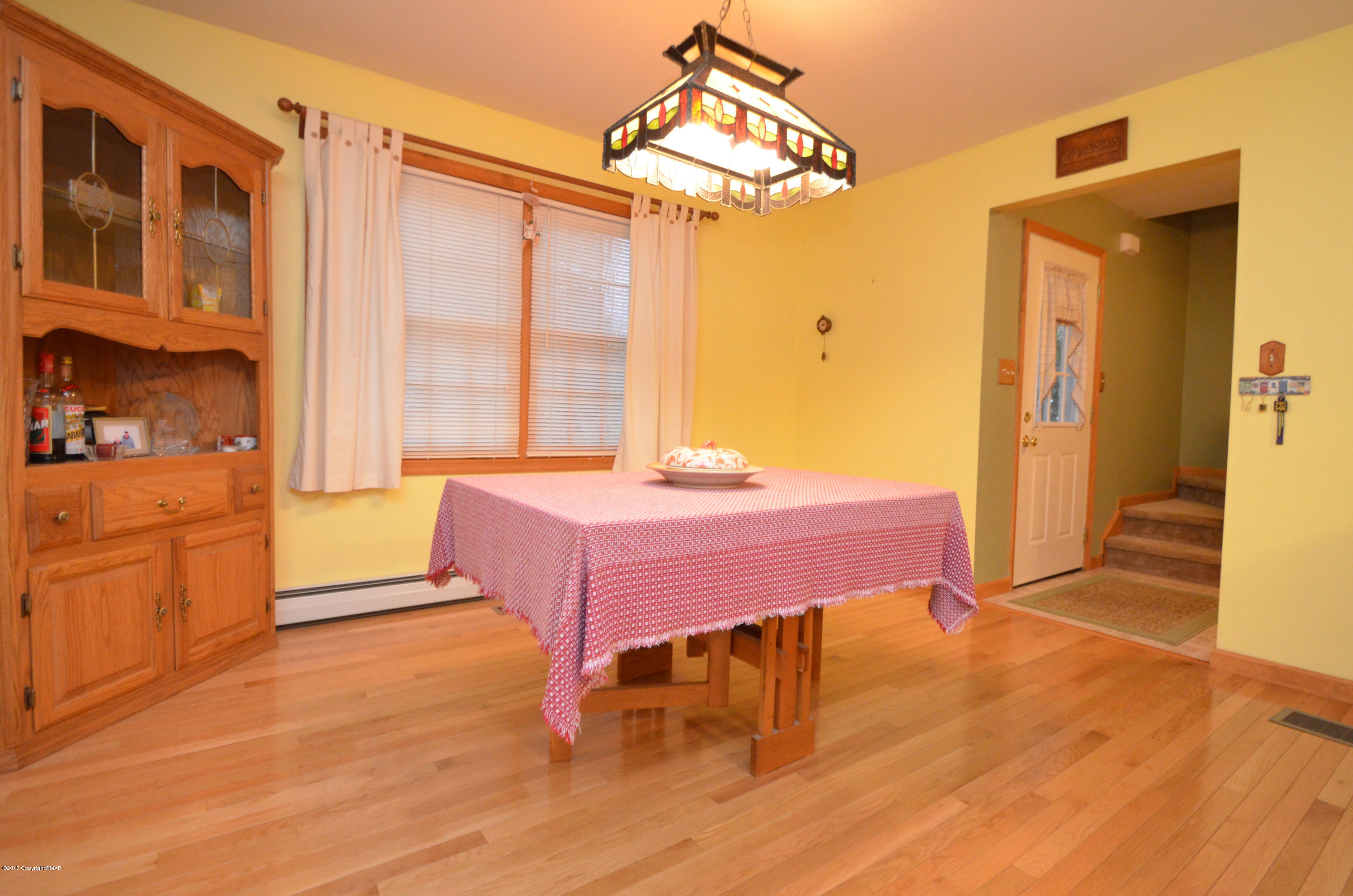699 Buckle Boot Road Henryville, PA 18332 - Photo 4 of 26 a spacious bedroom with a bed a table and potted plants