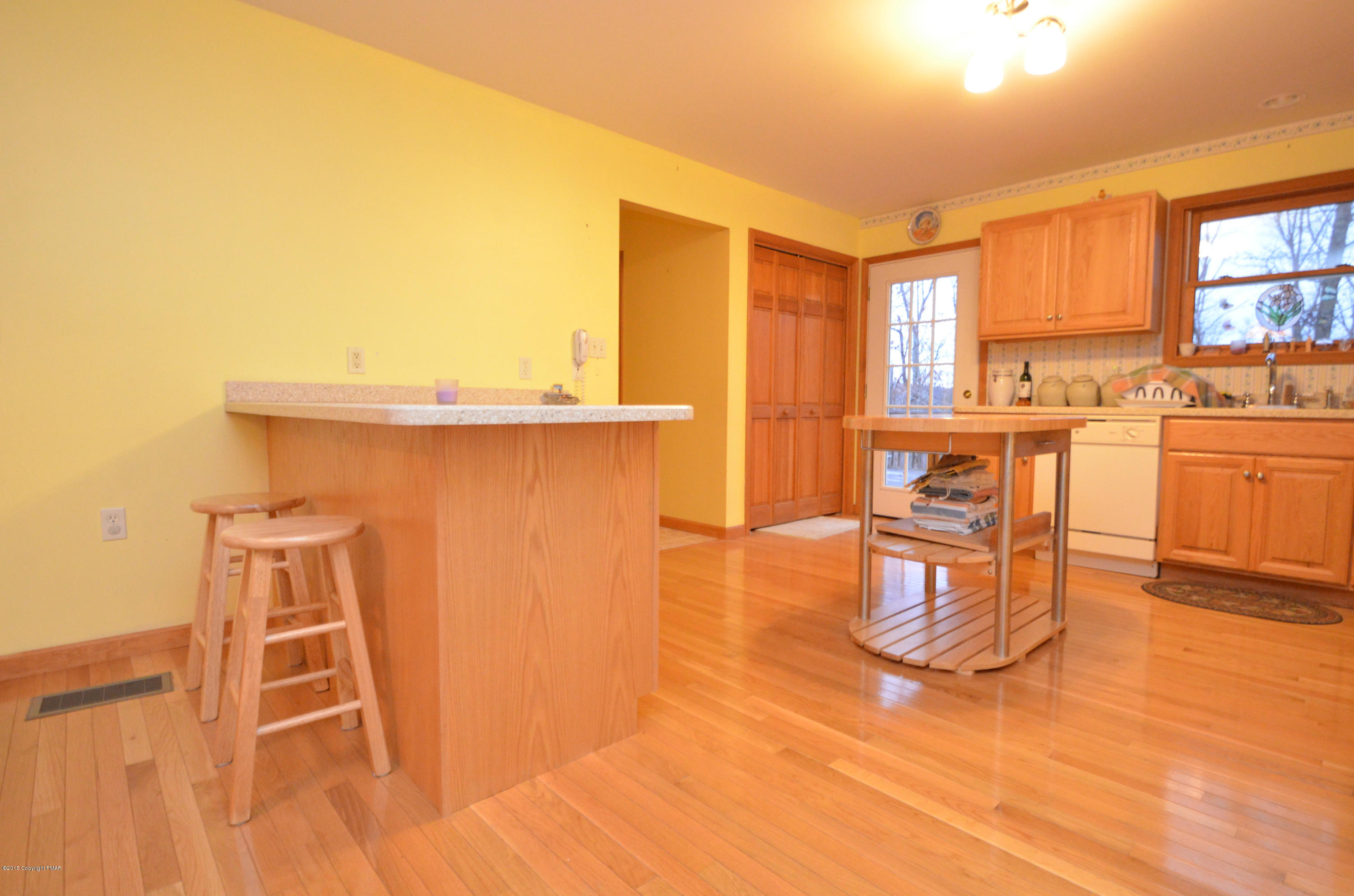 699 Buckle Boot Road Henryville, PA 18332 - Photo 5 of 26 a living room with furniture a large window with kitchen view