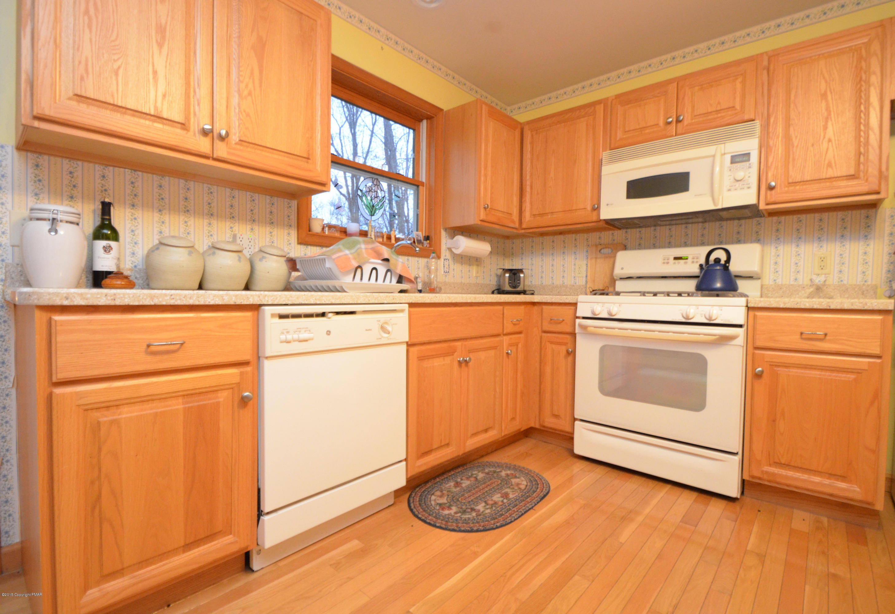 699 Buckle Boot Road Henryville, PA 18332 - Photo 6 of 26 a kitchen with a sink cabinets appliances and a window