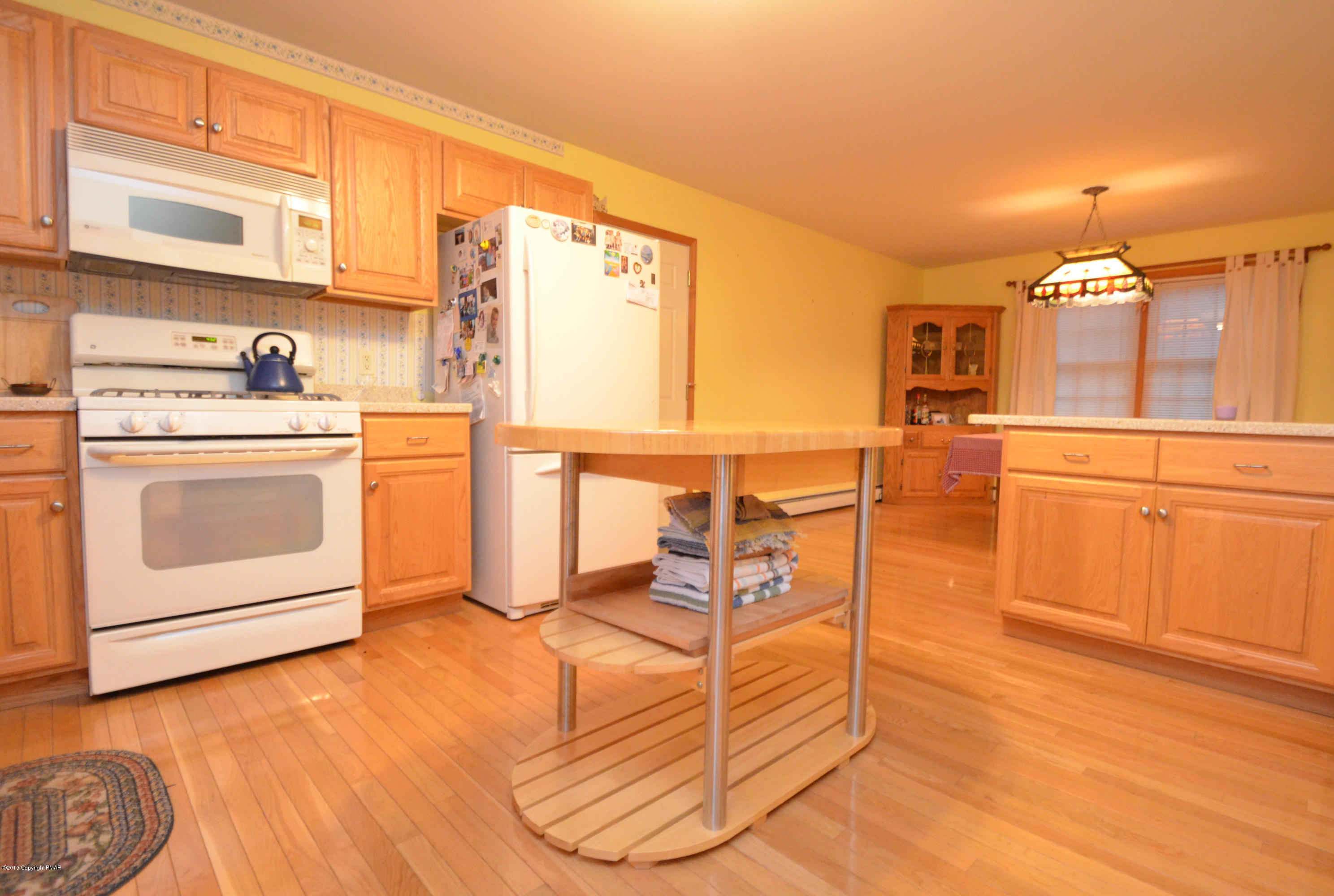 699 Buckle Boot Road Henryville, PA 18332 - Photo 9 of 26 a kitchen with stainless steel appliances granite countertop a stove a sink and a refrigerator