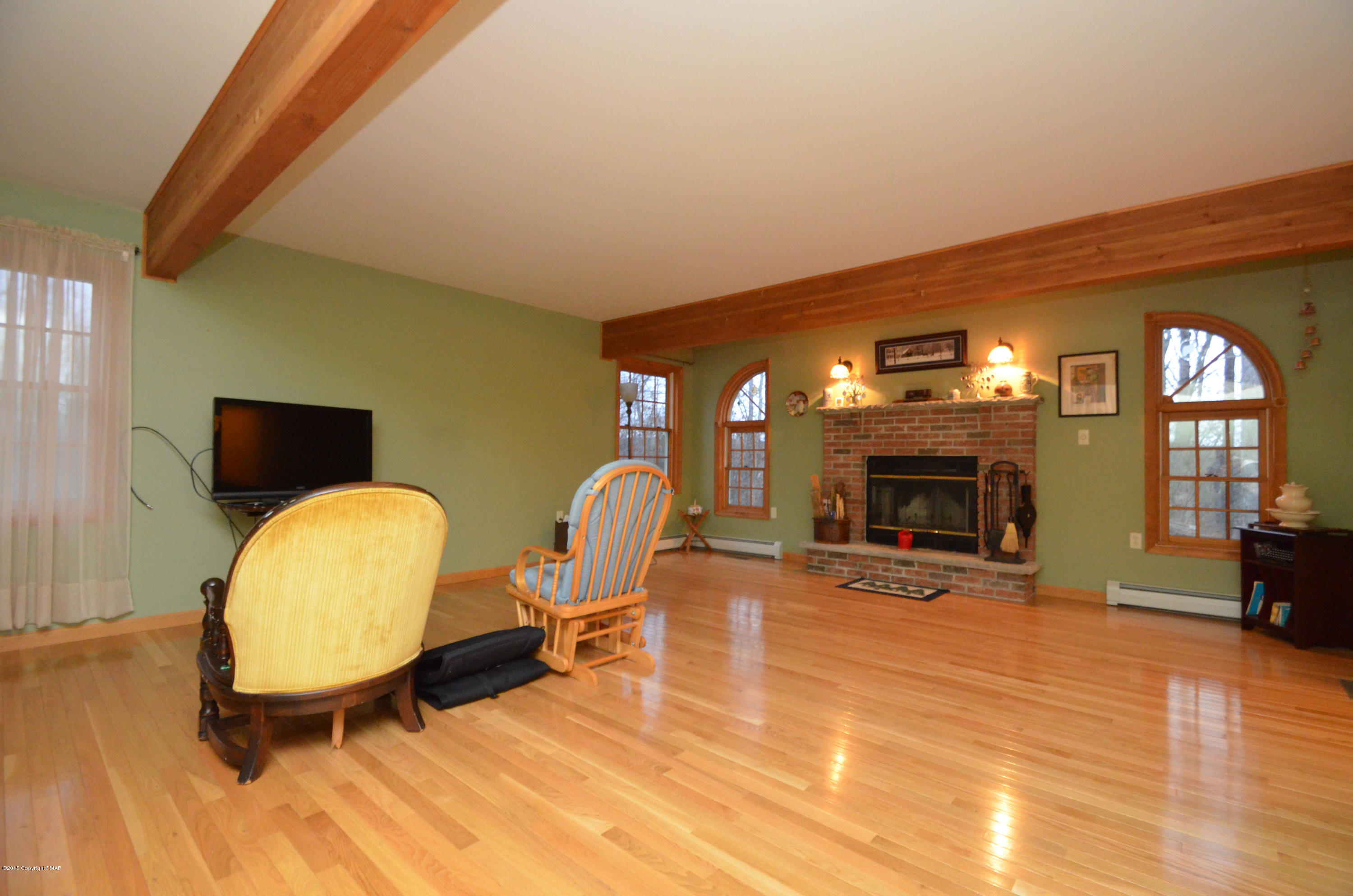 699 Buckle Boot Road Henryville, PA 18332 - Photo 10 of 26 a view of a livingroom with furniture and a fireplace