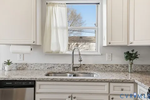 a kitchen with granite countertop a stove and a sink