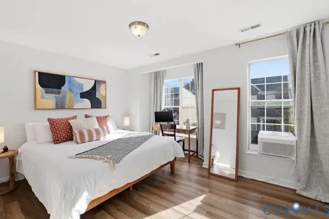 a bedroom with a bed and wooden floor