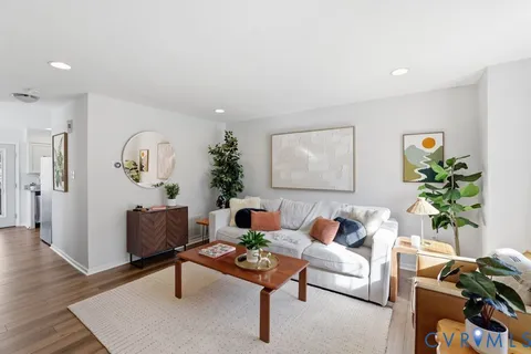 a living room with furniture and wooden floor