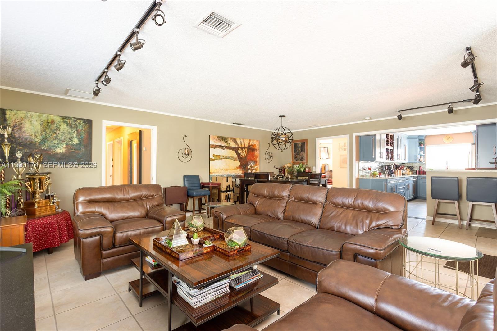 4548 Southwest 28th Way Dania Beach, FL 33312 - Photo 12 of 63 a living room with furniture couches and a dining table with wooden floor