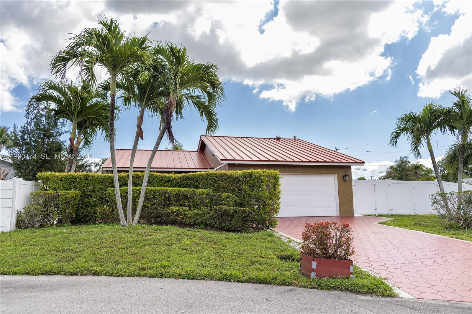 4548 Southwest 28th Way Dania Beach, FL 33312 - Photo 2 of 63 a front view of a house with garden