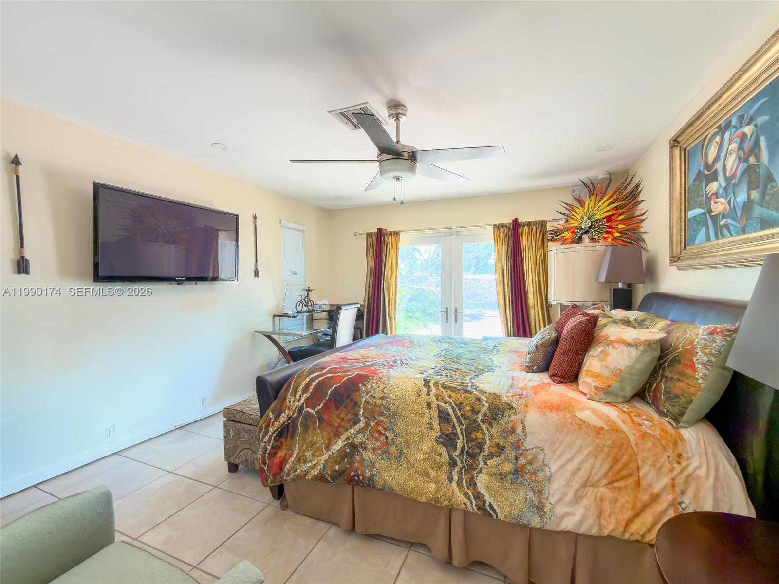 4548 Southwest 28th Way Dania Beach, FL 33312 - Photo 23 of 63 a bedroom with a bed and a flat screen tv