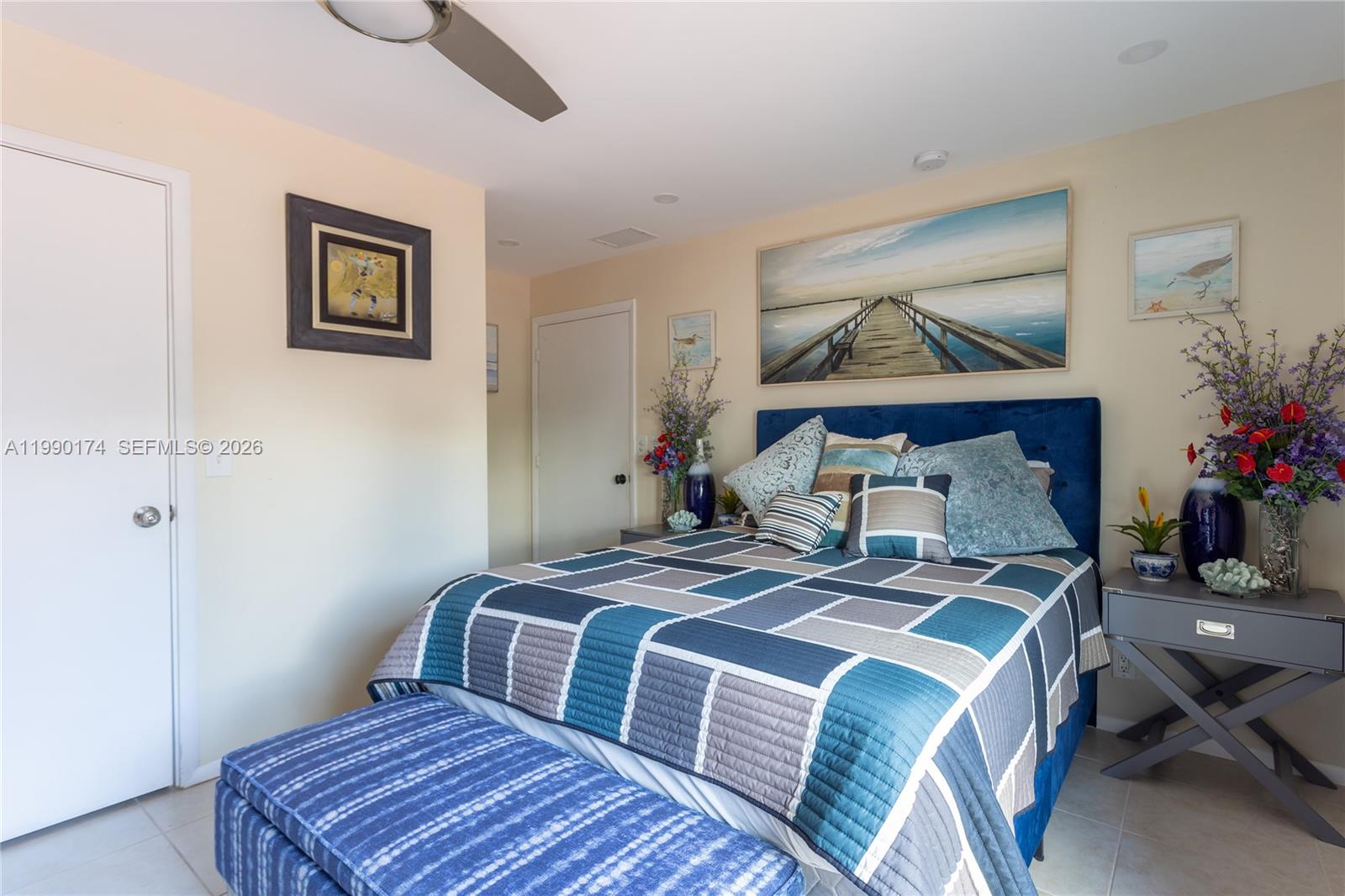 4548 Southwest 28th Way Dania Beach, FL 33312 - Photo 30 of 63 a bedroom with a bed and wooden floor