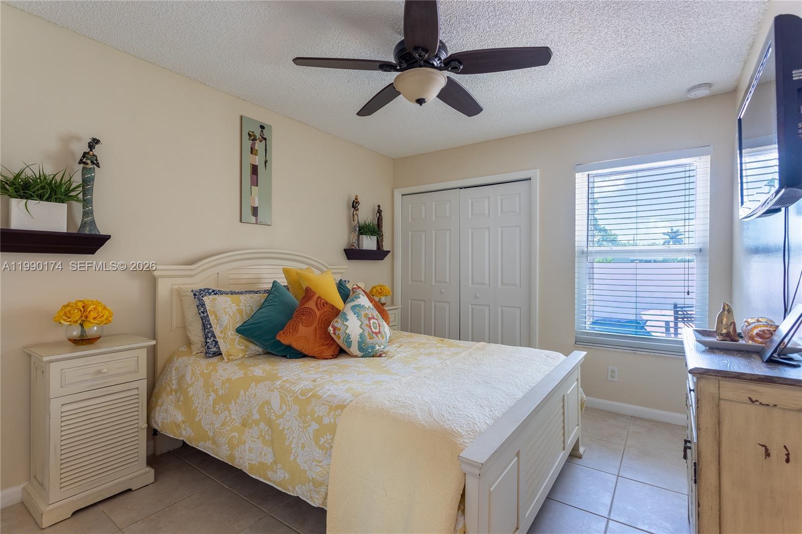 4548 Southwest 28th Way Dania Beach, FL 33312 - Photo 33 of 63 a bedroom with a bed and ceiling fan