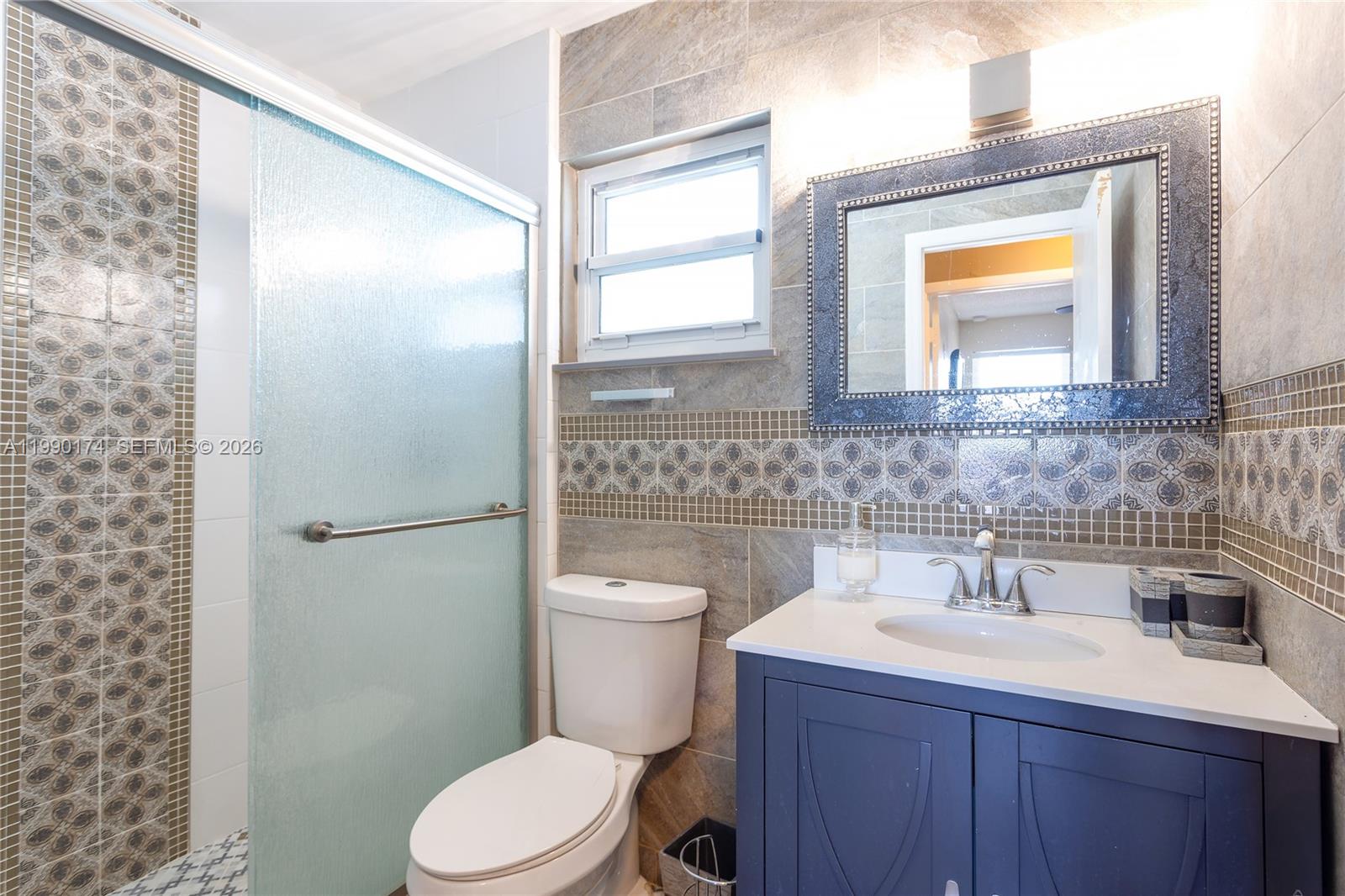 4548 Southwest 28th Way Dania Beach, FL 33312 - Photo 36 of 63 a bathroom with a sink a toilet and shower