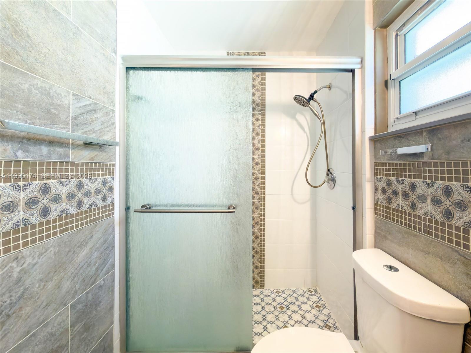 4548 Southwest 28th Way Dania Beach, FL 33312 - Photo 37 of 63 a bathroom with a shower toilet and sink