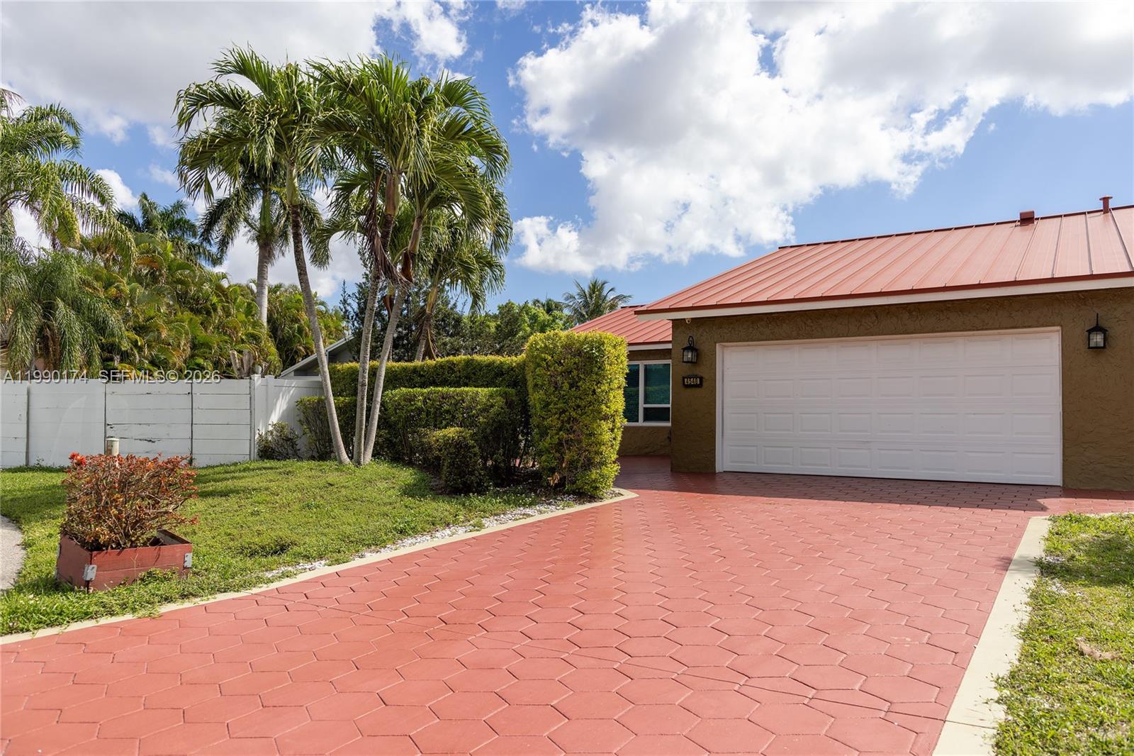 4548 Southwest 28th Way Dania Beach, FL 33312 - Photo 52 of 63 a front view of a house with a garden and entryway