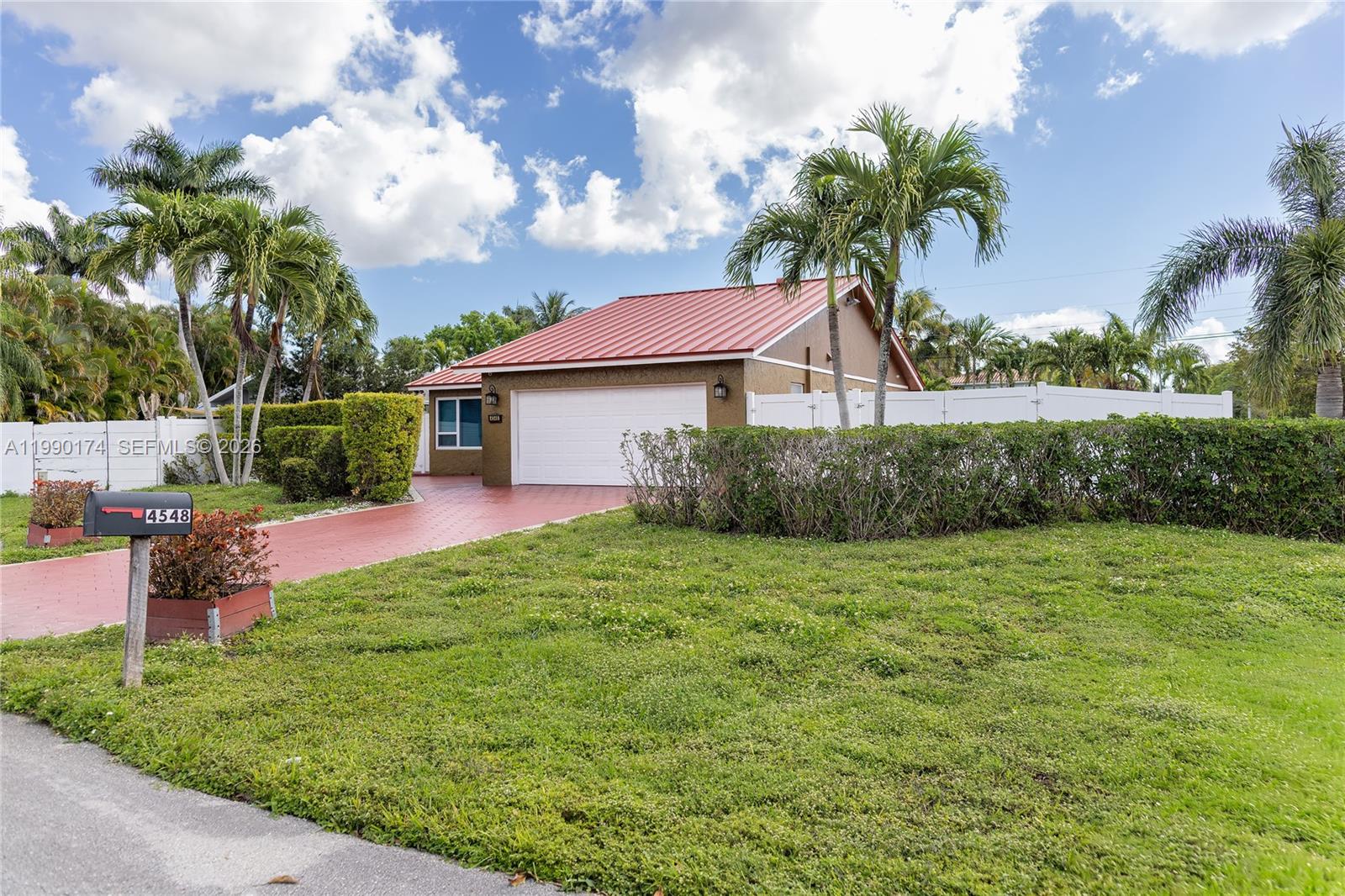 4548 Southwest 28th Way Dania Beach, FL 33312 - Photo 53 of 63 a front view of a house with a yard and garage