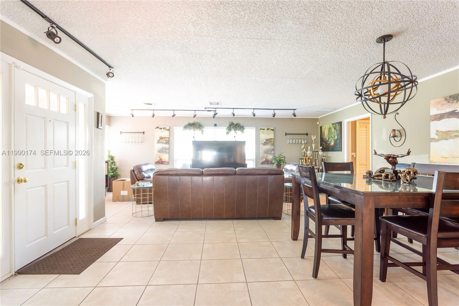 4548 Southwest 28th Way Dania Beach, FL 33312 - Photo 7 of 63 a view of a dining room with furniture and chandelier