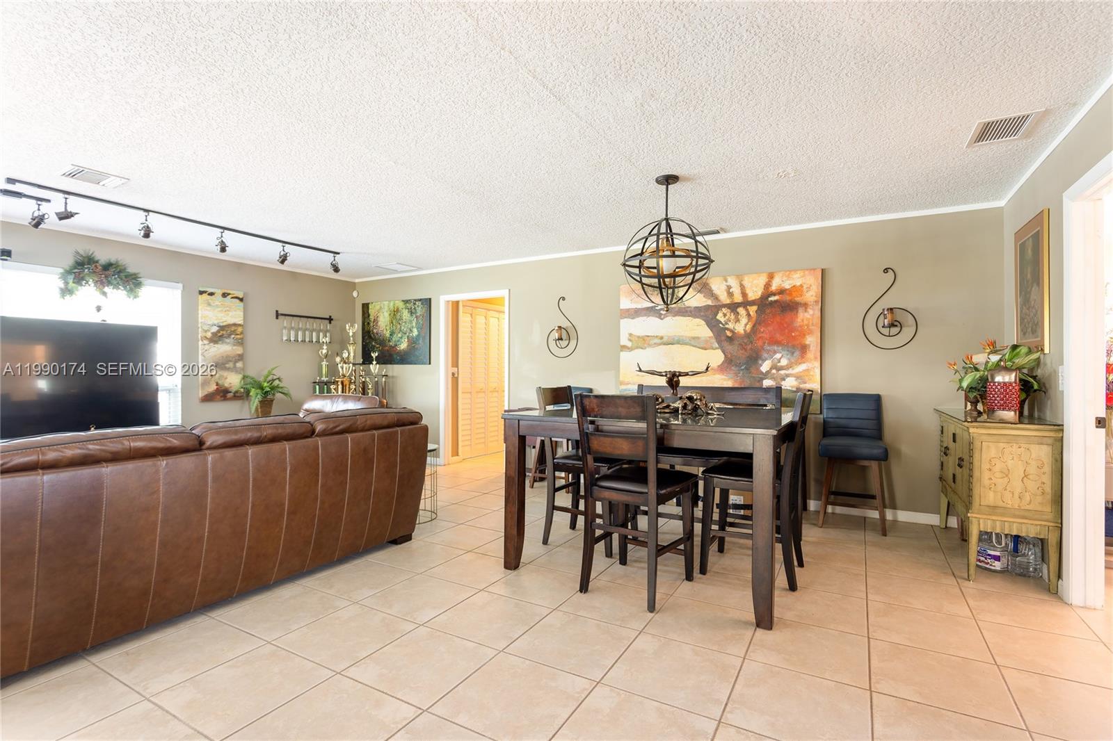 4548 Southwest 28th Way Dania Beach, FL 33312 - Photo 8 of 63 a view of a dining room with furniture and chandelier