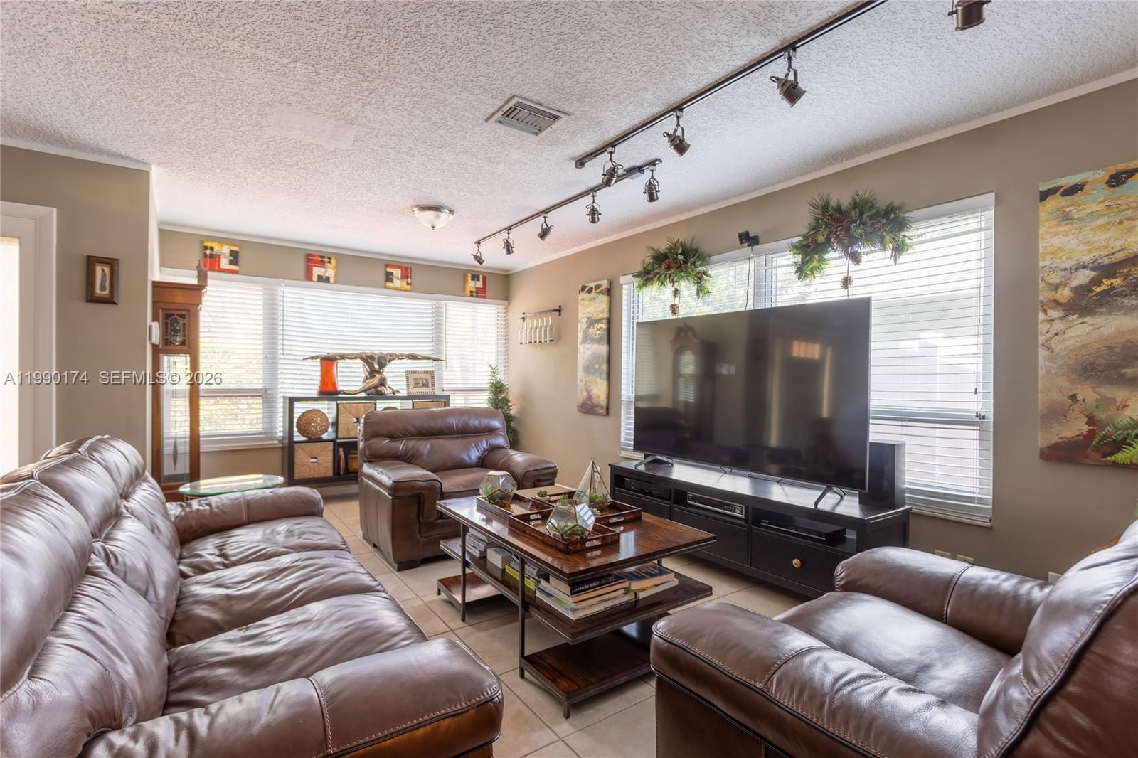 4548 Southwest 28th Way Dania Beach, FL 33312 - Photo 9 of 63 a living room with furniture and a flat screen tv