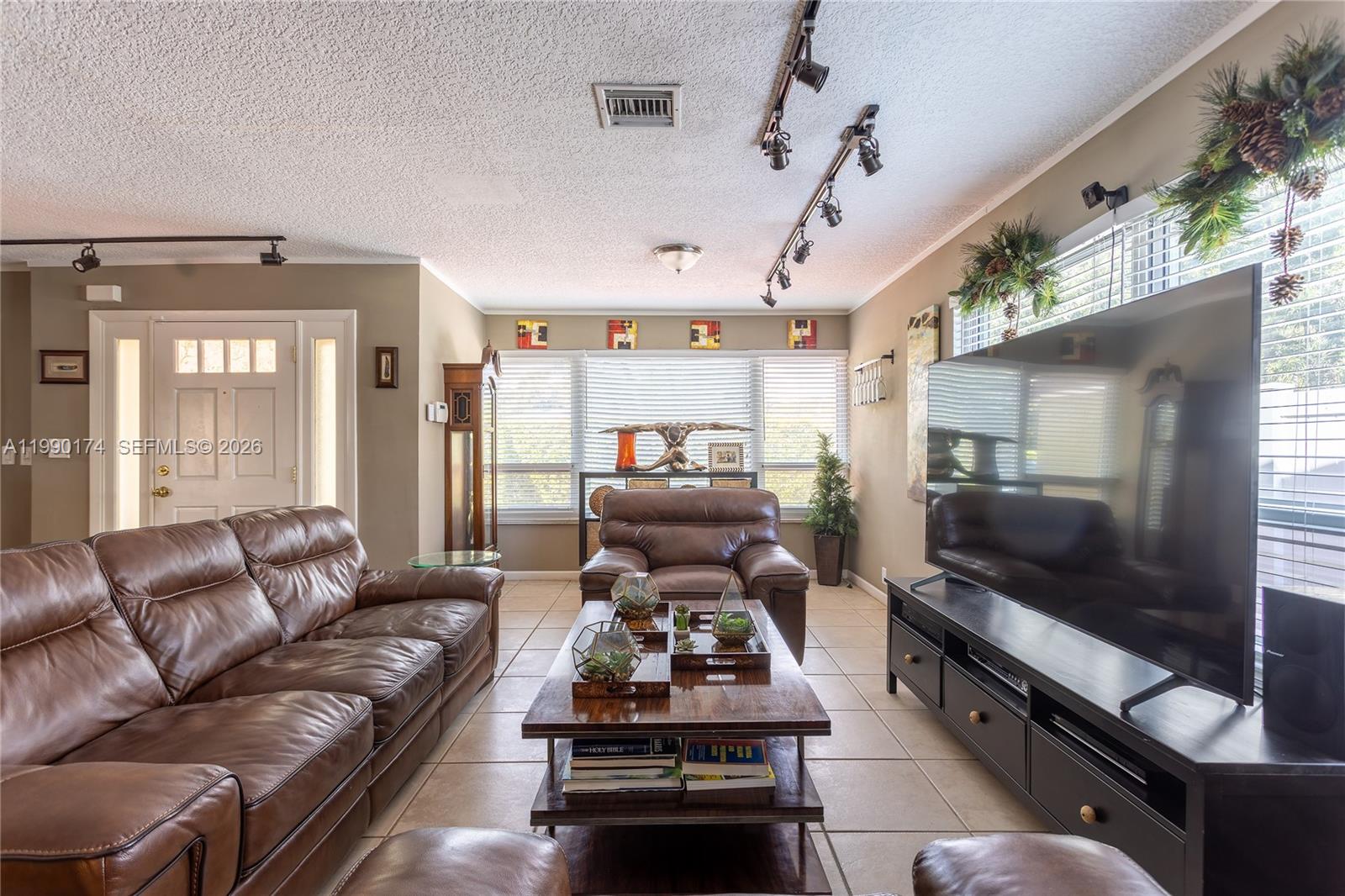 4548 Southwest 28th Way Dania Beach, FL 33312 - Photo 10 of 63 a living room with furniture and a flat screen tv