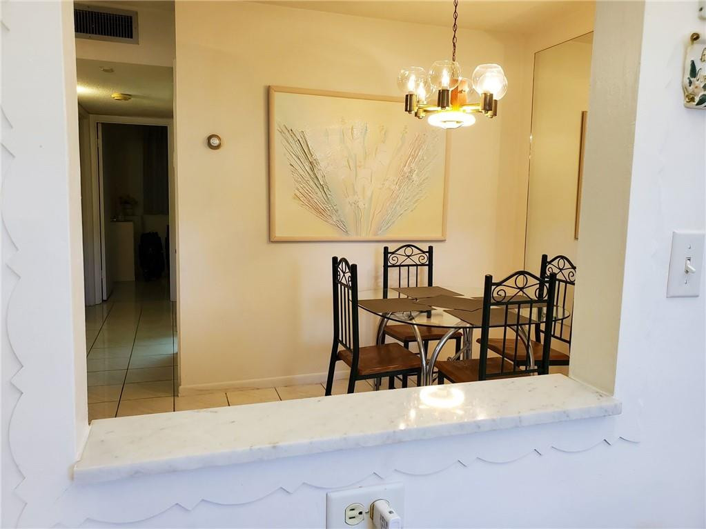 5300 Washington Street, Unit H136 Hollywood, FL 33021 - Photo 13 of 38 a view of a dining room with furniture and chandelier