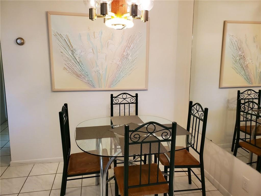 5300 Washington Street, Unit H136 Hollywood, FL 33021 - Photo 14 of 38 a view of a dining room with furniture and wooden floor