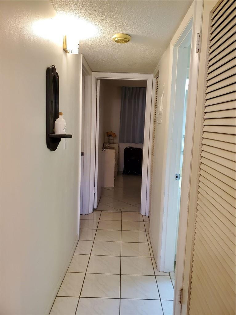 5300 Washington Street, Unit H136 Hollywood, FL 33021 - Photo 15 of 38 a view of a hallway with closet and a fireplace