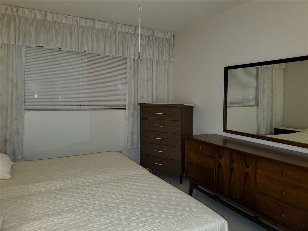5300 Washington Street, Unit H136 Hollywood, FL 33021 - Photo 17 of 38 a room with a dresser and a mirror