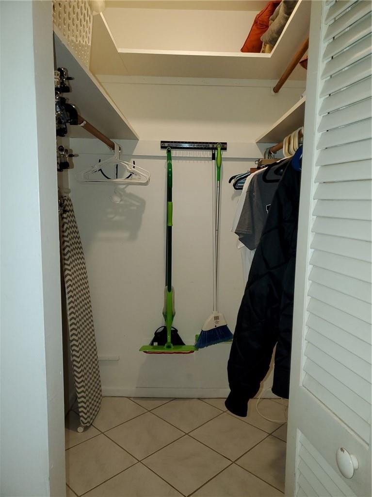 5300 Washington Street, Unit H136 Hollywood, FL 33021 - Photo 19 of 38 a view of walk in closet with clothes and shoes
