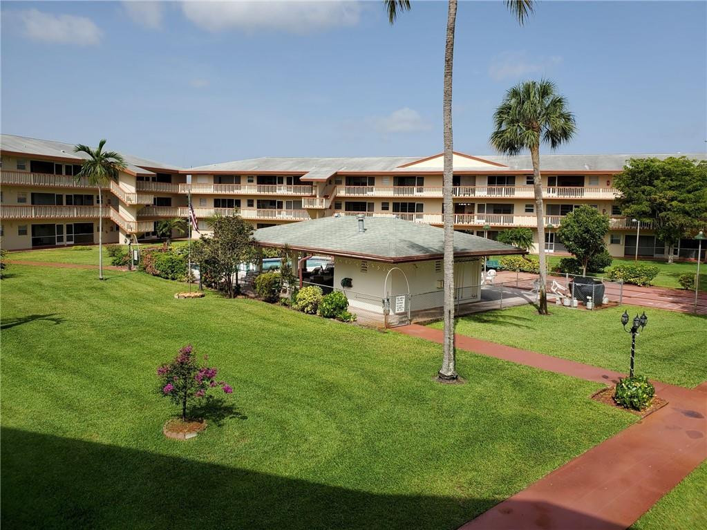 5300 Washington Street, Unit H136 Hollywood, FL 33021 - Photo 31 of 38 a view of a big house with a big yard and potted plants