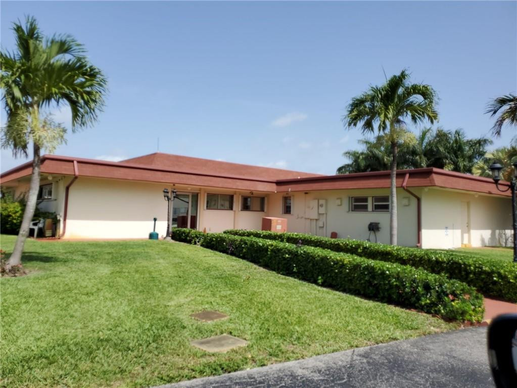 5300 Washington Street, Unit H136 Hollywood, FL 33021 - Photo 38 of 38 a front view of a house with a garden and yard