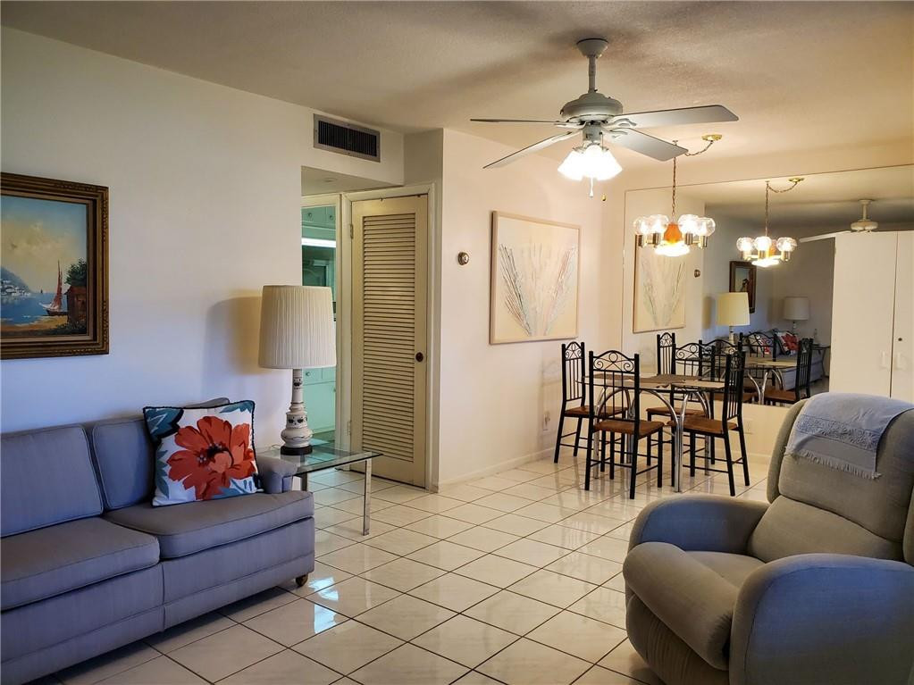 5300 Washington Street, Unit H136 Hollywood, FL 33021 - Photo 5 of 38 a living room with furniture and a chandelier