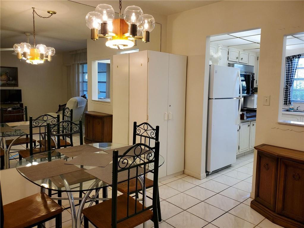 5300 Washington Street, Unit H136 Hollywood, FL 33021 - Photo 8 of 38 a view of a dining room with furniture and chandelier