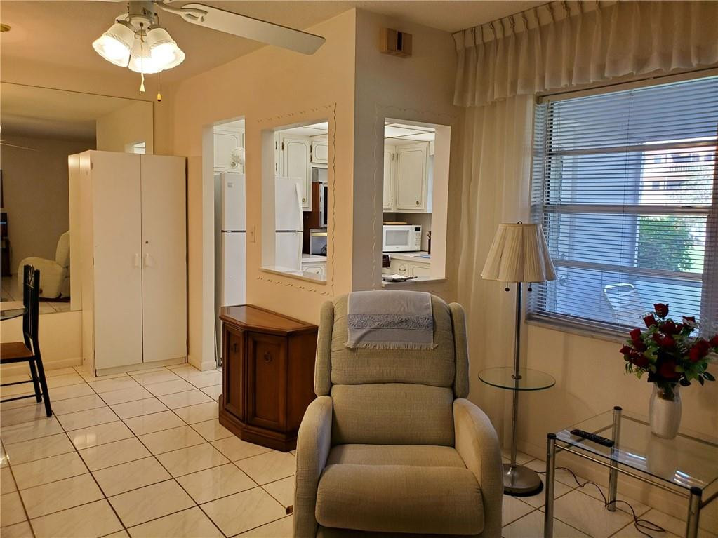 5300 Washington Street, Unit H136 Hollywood, FL 33021 - Photo 9 of 38 a living room with furniture and a chandelier