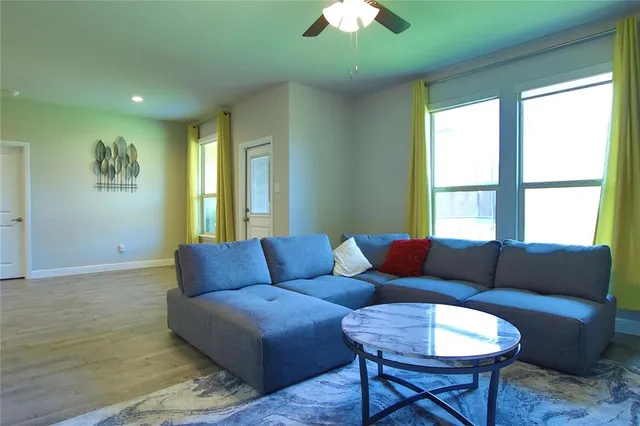 a living room with furniture and a large window