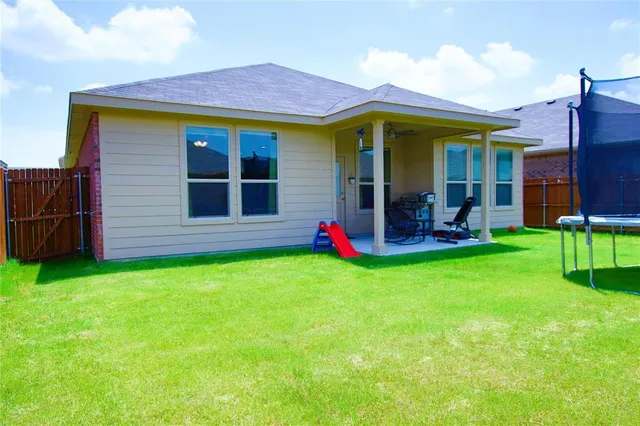 a view of a house with a backyard and porch