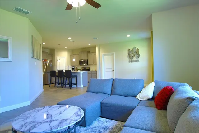 a living room with furniture and a chandelier
