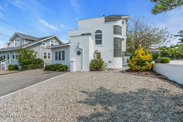 front view of a house with potted plants