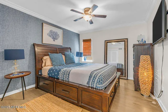 a bedroom with a bed and a potted plant