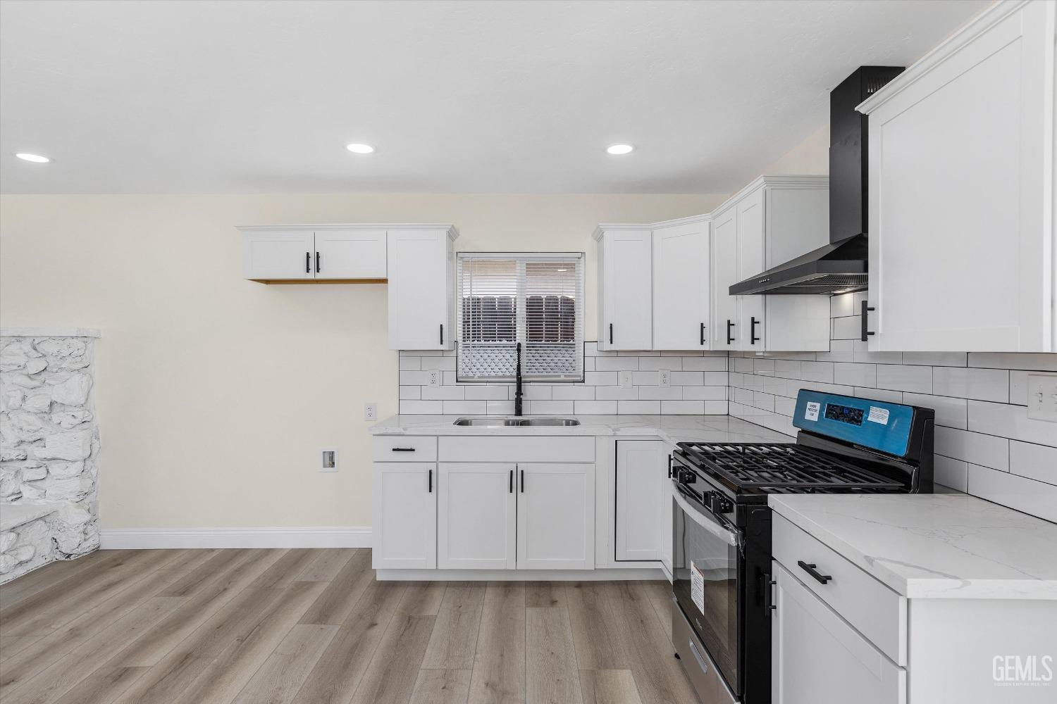 Undisclosed Address Bakersfield, CA 93312 - Photo 13 of 23 a kitchen with a sink cabinets and wooden floor