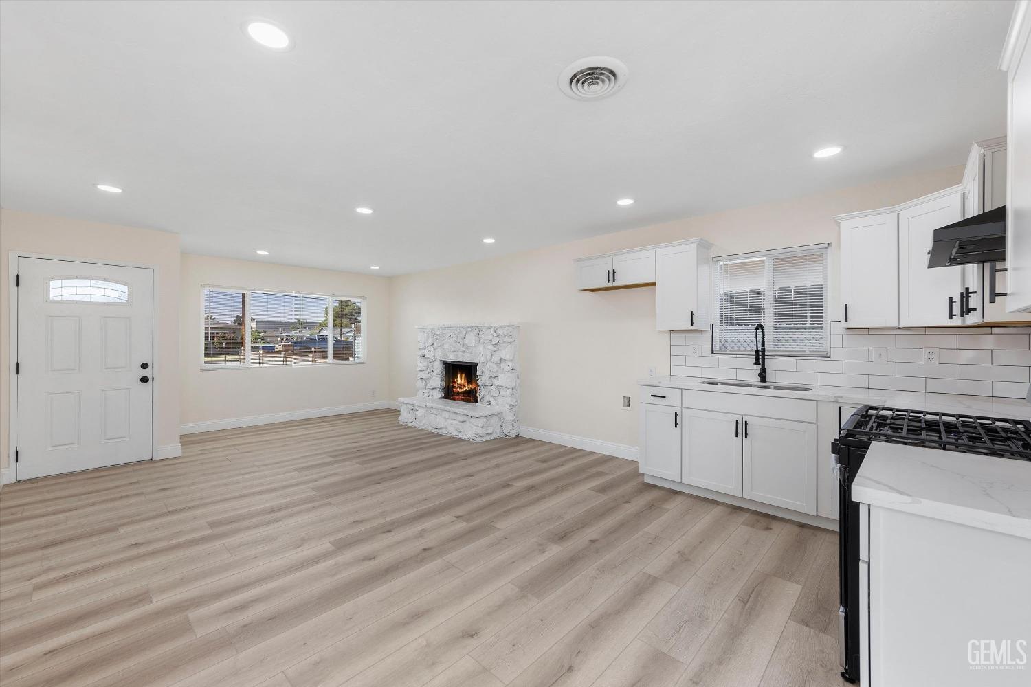 Undisclosed Address Bakersfield, CA 93312 - Photo 14 of 23 a large white kitchen with kitchen island a sink stainless steel appliances and cabinets