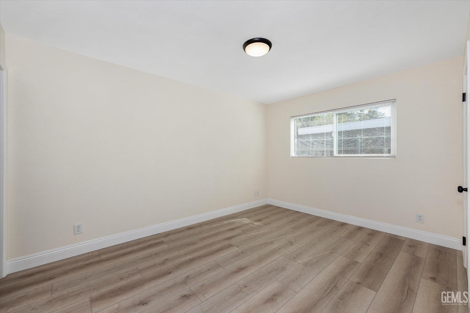 Undisclosed Address Bakersfield, CA 93312 - Photo 15 of 23 an empty room with wooden floor and windows