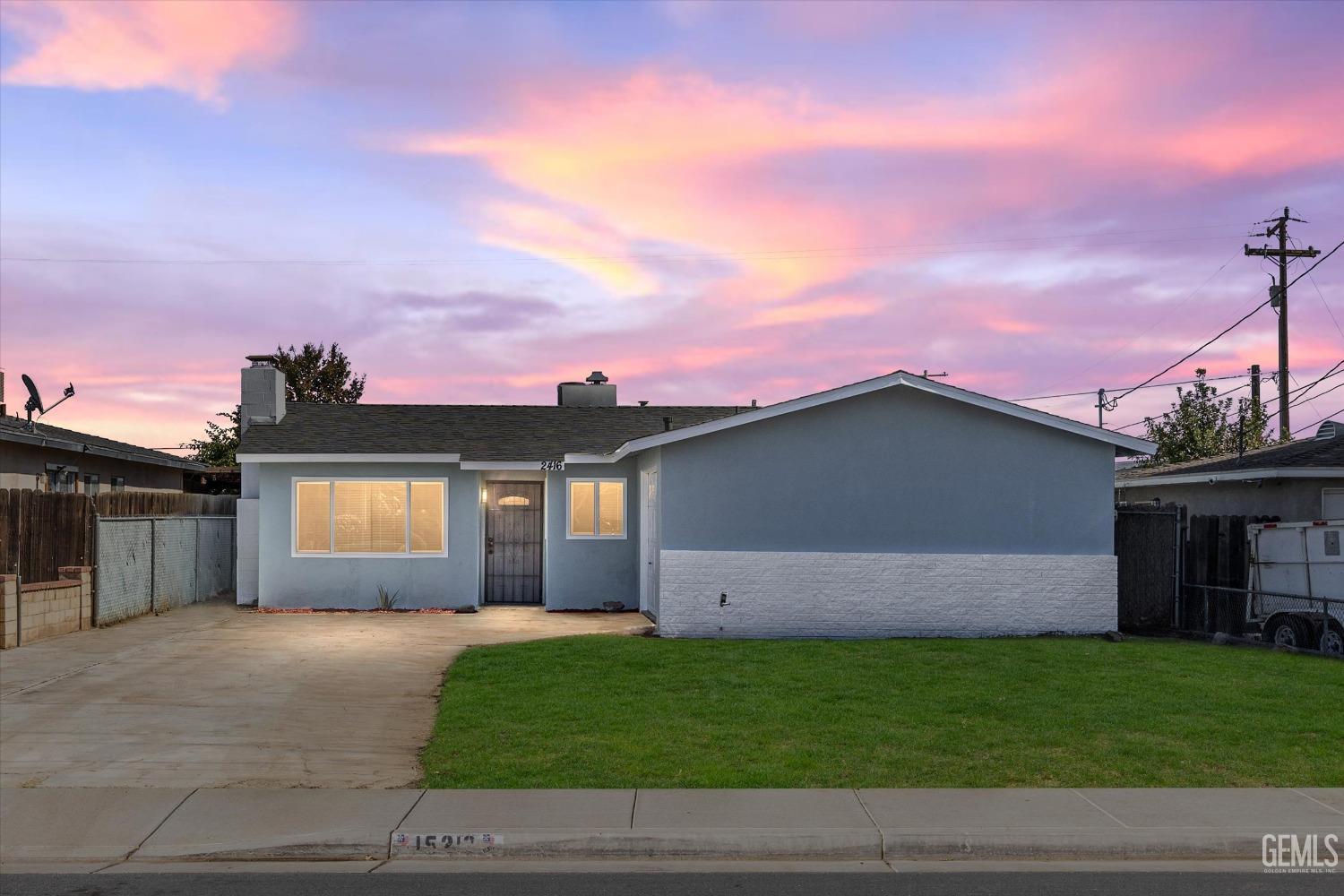 Undisclosed Address Bakersfield, CA 93312 - Photo 2 of 23 a front view of a house with a garden and yard