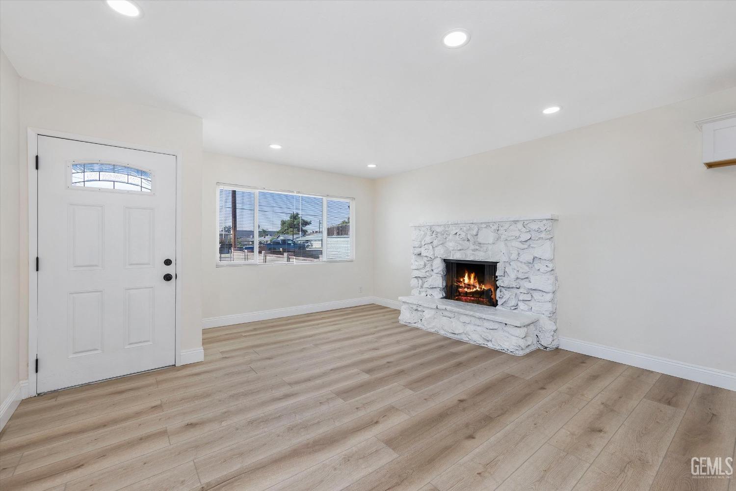 Undisclosed Address Bakersfield, CA 93312 - Photo 6 of 23 a view of an empty room with a fireplace and a window