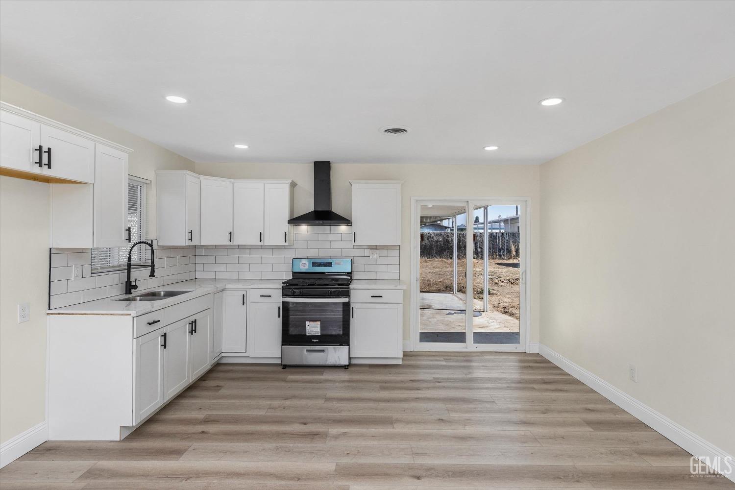 Undisclosed Address Bakersfield, CA 93312 - Photo 10 of 23 a kitchen with stainless steel appliances a sink stove and cabinets