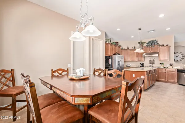 a view of a dining room with furniture and a chandelier