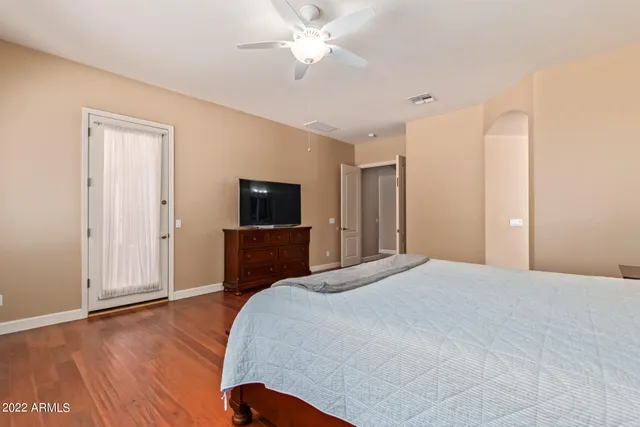 a bedroom with a bed and a flat screen tv